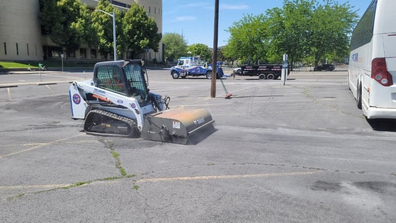 Sweeping with a Bobcat after an oil spill cleanup in Spokane